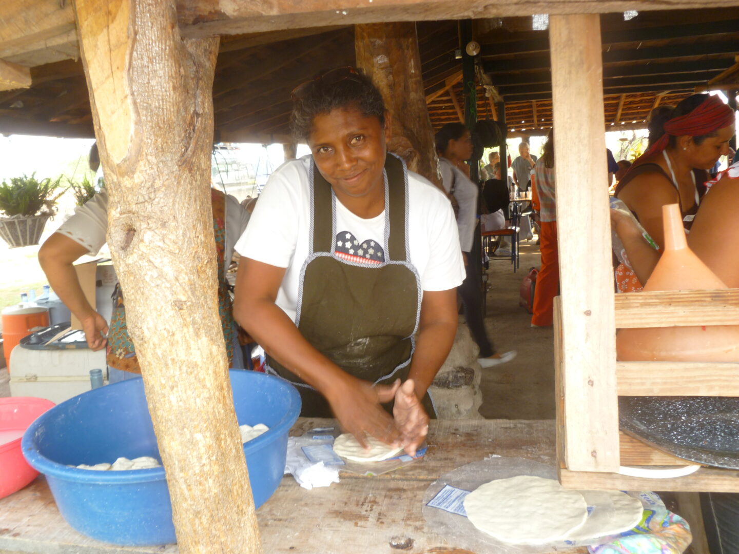 A Woman Rolling Dough on a Surface